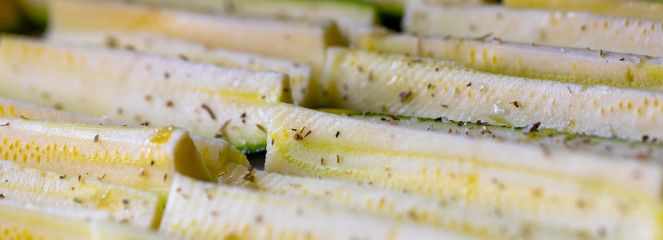 Panorama banner of fresh seasoned zucchini slices
