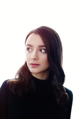 Fototapeta premium Pretty young brunette woman posing against white studio background 