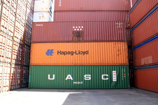 HAMBURG, GERMANY - JUNE 30, 2019: Shipping containers of HAPAG-LLOYD and UASC stacked at the Port of Hamburg, symbolizing the merger of the two companies that was completed in 2017