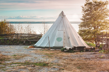 a tent on the lake at sunset