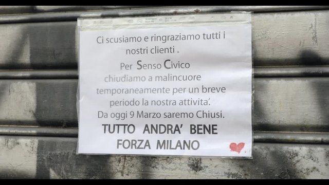 Apology sign on closed shop in Milan, Italy during COVID-19 shutdown. Store shut in Milano, Italian city and coronavirus emergency. Tutto andr&agrave; bene - Everything will be fine