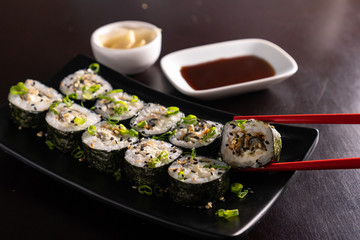 sushi on a plate with chopsticks