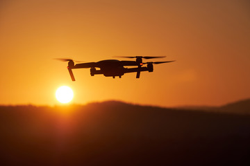 Fototapeta na wymiar Drone flying at the sunset on red sky