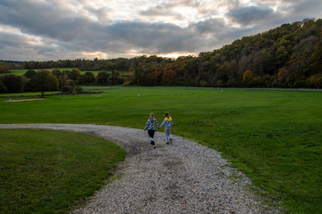 Two girls walking on the road