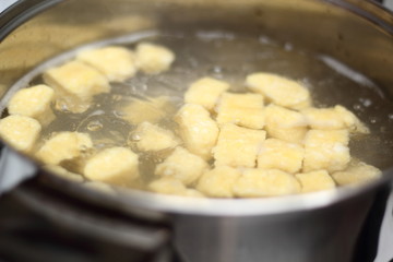 Gnocchi being prepared. Boiling. Dough dumplings with cheese.