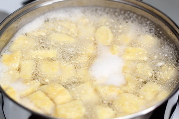 Gnocchi being prepared. Boiling. Dough dumplings with cheese.