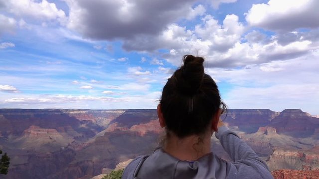 Woman taking picture of grand canyon in usa in slow motion 250fps