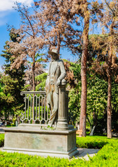 Fototapeta premium Bronze sculpture statue of the painter Lado Gudiashvili in broad brimmed hat in April 9 Park Tbilisi Georgia.
