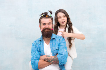 Making me happy. Daughter creating fathers hair. Handsome father with little girl. Happy father and...