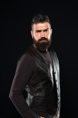 Fototapeta na wymiar Man confident and brutal style black background. Handsome face. Man with beard in black leather clothes. Barbershop concept. Grow mustache. Fashion model. Strict mature face. Facial hair. Male face