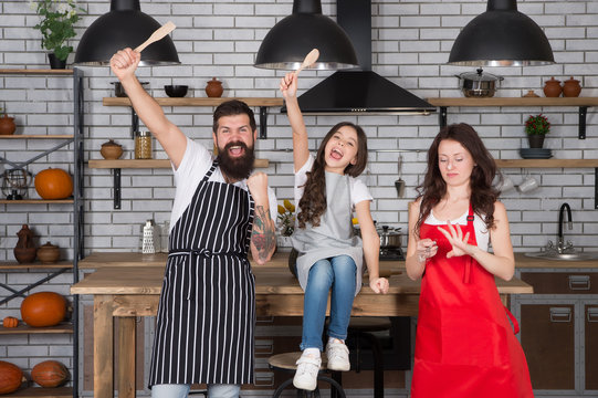 Going Crazy Together. Child With Parents Doing Morning Breakfast. Friendly Family In Kitchen. Mothers Day. Cooking Healthy Food At Home. Family Preparing Meal In Kitchen. Happy Family In The Kitchen