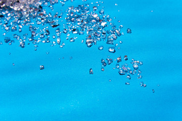 large crystals of sea salt on a blue background. Free copy space. Abstract small Bright texture crystal.