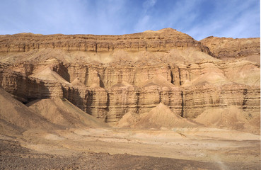 The high sandstone rocks in the desert and the blue sky with clouds 