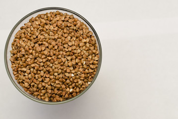 buckwheat groats on a light background, closeup texture