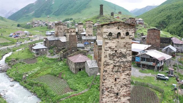 Tower of Lower Chazhash Castle and Ushguli village at the foot of Mt. Shkhara. Picturesque and gorgeous scene. Rock tower towers and old houses in Ushguli.