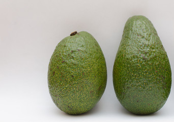 ripe green avocado on a light background
