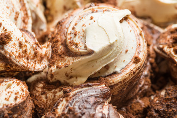Cookie flavour gelato surface - full frame detail. Close up of a white and brown Ice cream with...