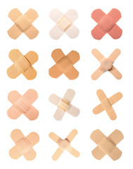Set with sticking plasters on white background, top view