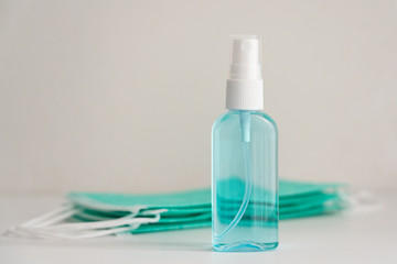 Medical masks and hand sanitizer blue bottle, anti-infective hygienic and health protection concept, Coronavirus Covid-19 protection