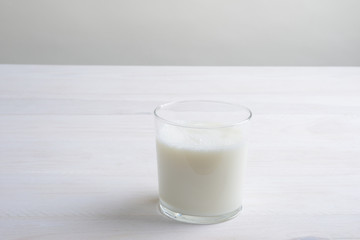 Vaso de leche en la mesa blanca