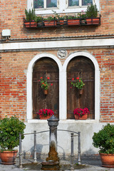 Fototapeta na wymiar Detail of architecture and Iron Fountain in Murano, Venice, Veneto, Italy