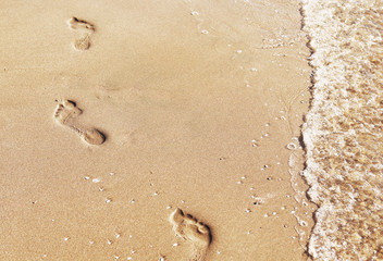 footprints in the sand by the sea