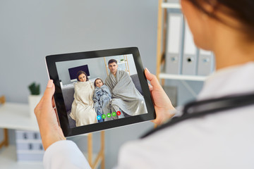 Telemedicine concept. Family doctor online call. Shoulder view doctor therapist speaks with a sick...