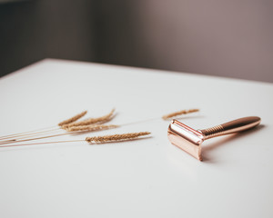 woman shaving razor with dry flowers
