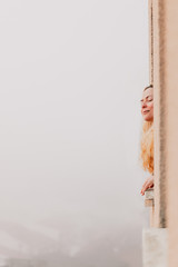 Woman bending over the window watching outside and breathing