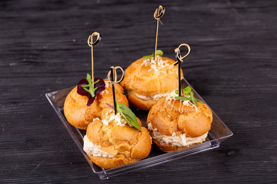 Canape with a pate of chicken, beef and duck, served in ecklers with greens