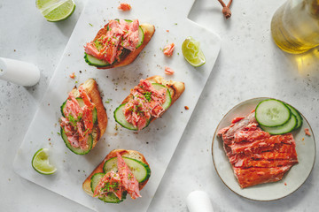 Toasts with fresh cucumber and smoked salmon served with lime shavings.