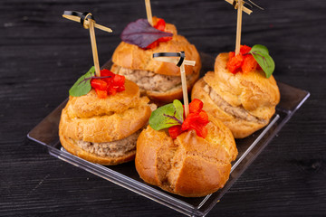 Canape with a pate of chicken, beef and duck, served in ecklers with greens