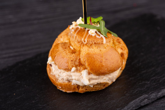 Canape with a pate of chicken, beef and duck, served in ecklers with greens