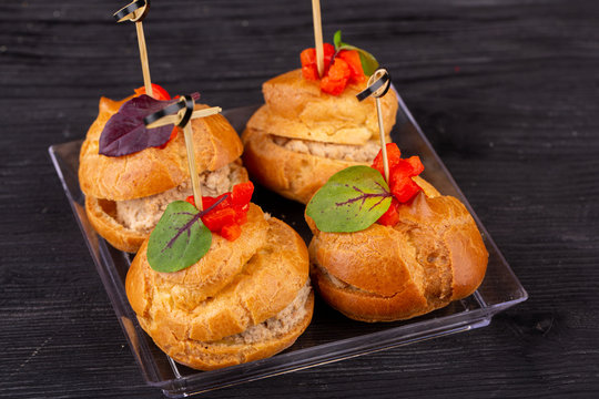 Canape with a pate of chicken, beef and duck, served in ecklers with greens