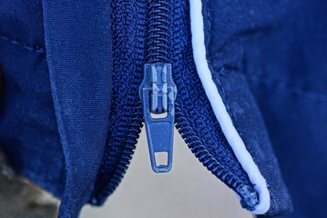 one metal zip on a piece of blue matter on clothes