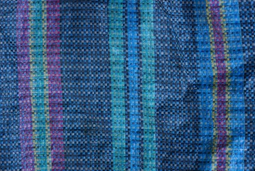 colored fabric texture from a piece of cloth on an old bag with a pattern