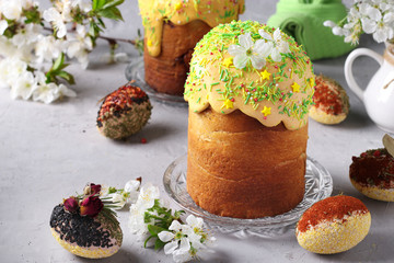Easter cakes with colored glaze and decoration sprinkling and Easter eggs decorated with spices and cereals, Closeup