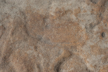 Natural stone of gray and yellow spots color with a chipped uneven texture background