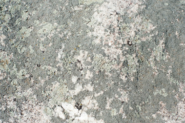 Natural stone of grey color with a chipped uneven texture background