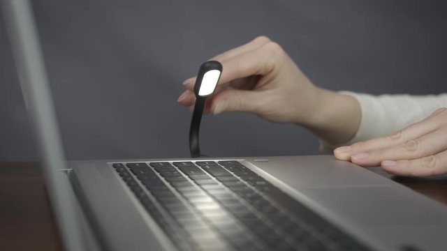Lamp for computer. Turn on the lamp on the laptop.