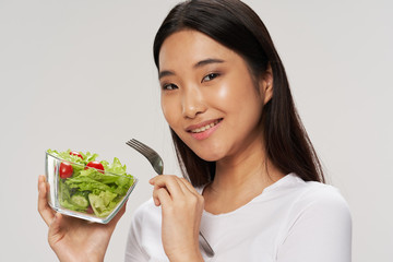 Cheerful woman Asian appearance salad meal