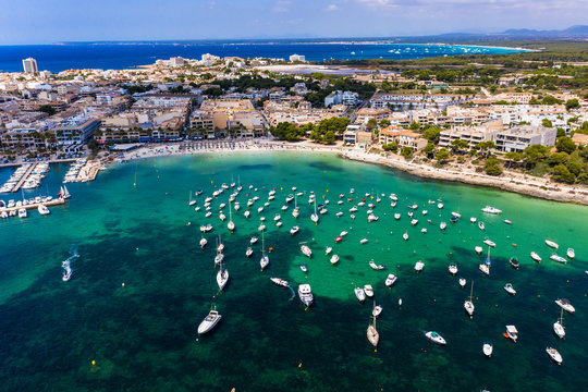 Spain, Balearic Islands, Colonia de Sant Jordi, Aerial view of large number of boats floating in water near shore of coastal town