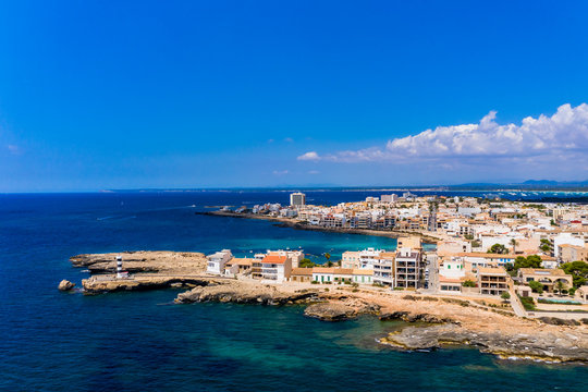 Spain, Balearic Islands, Colonia de Sant Jordi, Aerial view of town along shore of Cala Galiota bay in summer