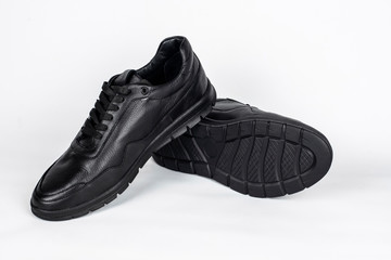 Men's leather waterproof shoes for comfortable use in wet cold weather in spring or autumn on light background