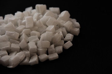 Coconut candied fruit on a black shiny background