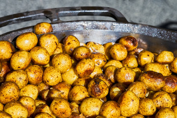 Fried baby potatoes in a frying pan. Top view