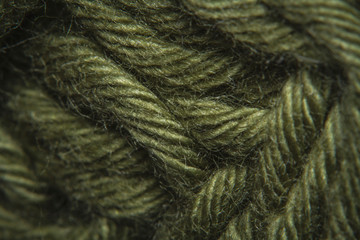 Close-up macro shots a green wool thread on the wool thread ball - obrazy, fototapety, plakaty