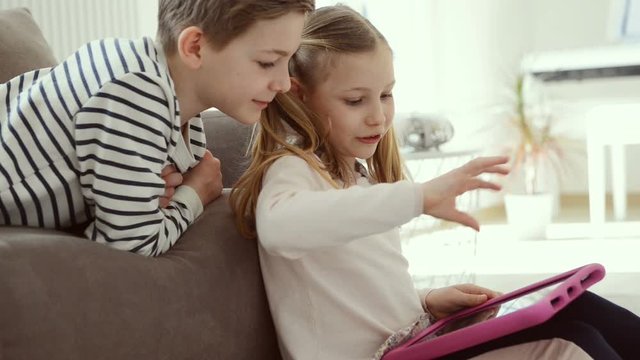 Teen children study with tablet at home due to coronavirus quarantine