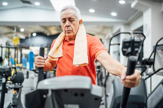 Senior man practising at stepper in gym