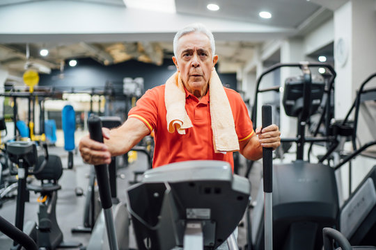 Senior man practising at stepper in gym